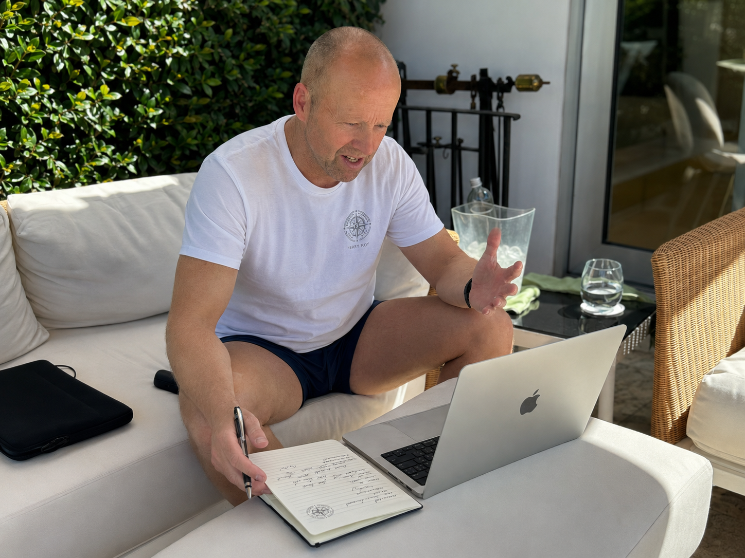 Terry Roy planning coaching work on a laptop
